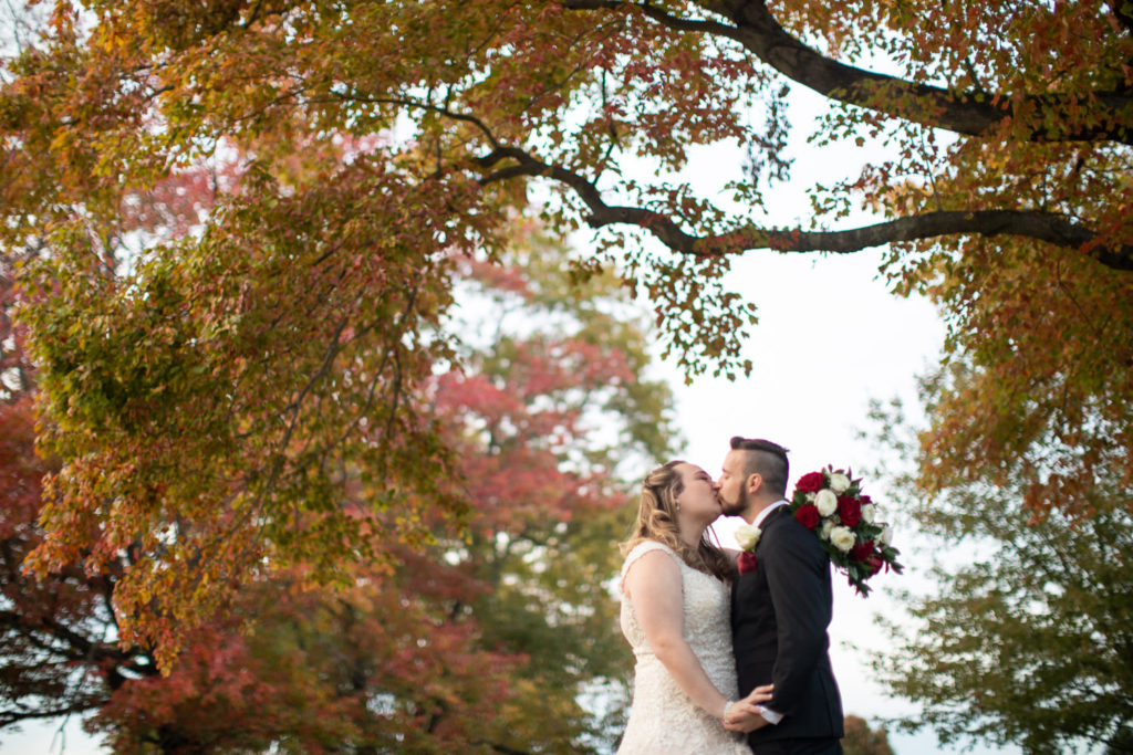 Emily and Tyler kissing after their wedding at Piney Branch Golf Club