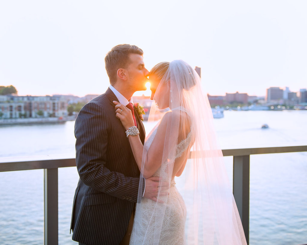 Tim kissing Heather on the forehead at the Four Seasons Baltimore at Sunset