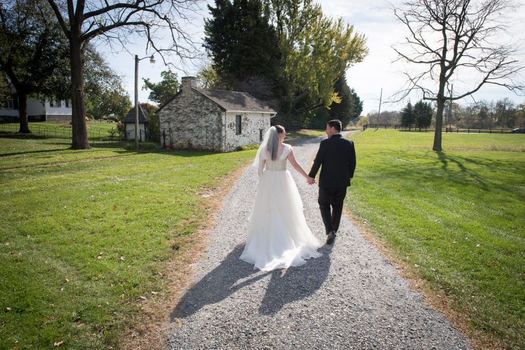 Jeannette and Spencer walk away together at the reception at Crown Rose Estate