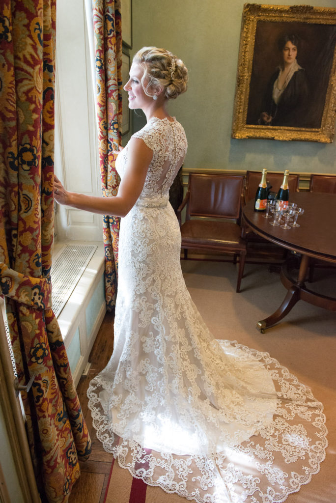 Michele in her wedding dress looking out the window at the Meridian House Washington DC