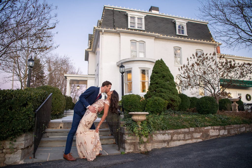 Nikita and Rob kissing at Ceresville Mansion before their engagement party