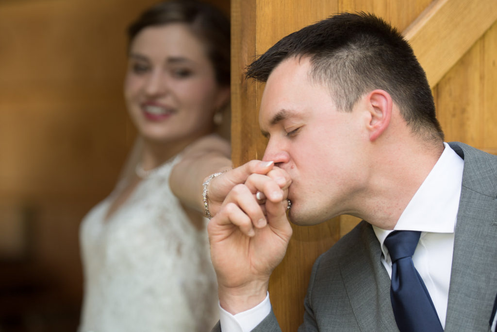 Matt kissing Shelby's hand for a first touch before the Anchor Inn wedding ceremony